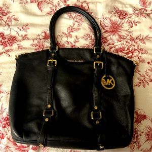 Michael Kors Black Shoulder Bag with gold zipper and buckles.
